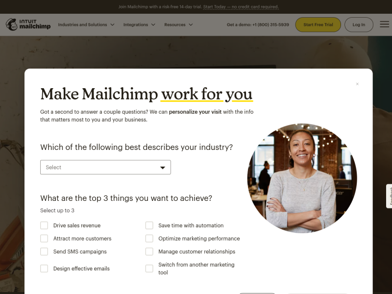 The Mailchimp homepage almost entirely covered by a white personalisation survey panel headed Make Mailchimp work for you, with an industry drop-down, a grid of goal checkboxes, and a photo of a smiling person; the actual homepage is only visible around the edges
